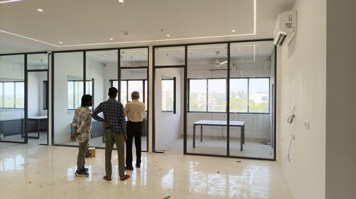 Bright office interior with freshly finished white walls and glass cabins