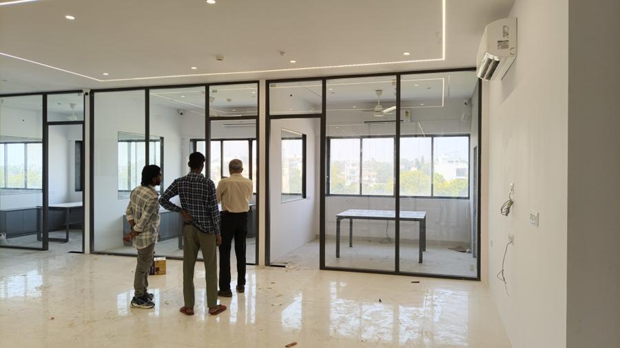 Bright office interior with freshly finished white walls and glass cabins